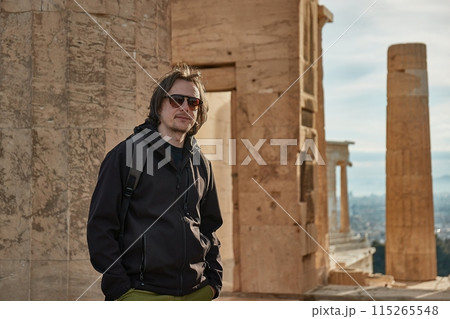 Acropolis of Athens, entrance gate pillars with tourist Acropolis of Athens, entrance gate pillars with tourist 115265548