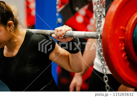 woman athlete preparing squat exercise at powerlifting competition woman athlete preparing squat exercise at powerlifting competition 115265632