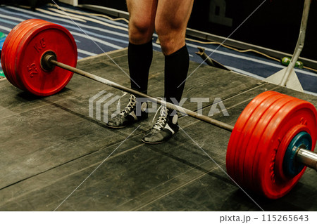 deadlift exercise at powerlifting competition, legs man in black knee socks 115265643