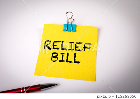 Relief Bill. A yellow notepad on a white office table 115265650