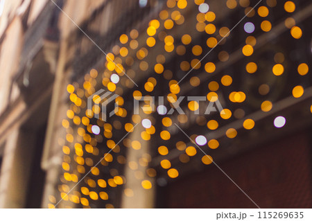Decorative outdoor string lights at night time, Defocused Background, night city life backdrop, party time with Yellow bokeh balls 115269635