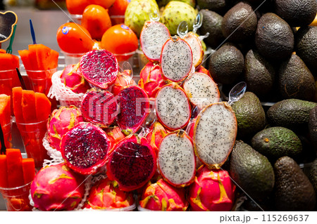 Fresh raw dragon fruit on open market. Healthy and food concept. Tropical fruits display at a farmers market Fresh raw dragon fruit on open market. Healthy and food concept. Tropical fruits display at a farmers market 115269637