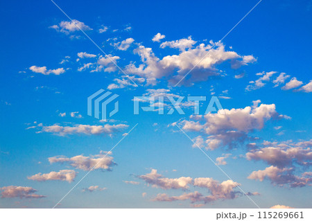 white cumulus clouds on a blue sky. beautiful weather condition nature background in morning light 115269661