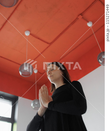 woman meditates and practices yoga, hands above her head woman meditates and practices yoga, hands above her head 115271449