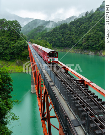 Northbound Train Crossing Lake Sesso in Japan 115271941