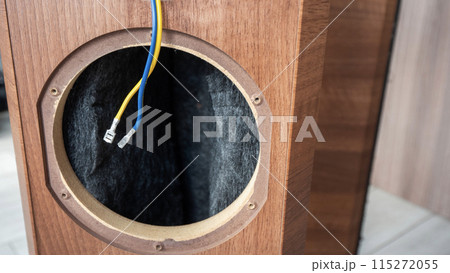 Disassembled speaker cabinet with visible internal wiring. 115272055
