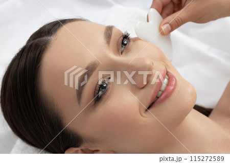 An attractive brunette at an appointment with a beautician 115272589