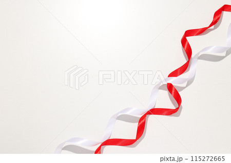 White and red ribbons on a light background White and red ribbons on a light background 115272665