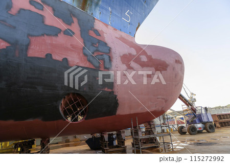 Cargo vessel in dry dock on ship repairing yard. Bulbous bow. Cargo vessel in dry dock on ship repairing yard. Bulbous bow. 115272992
