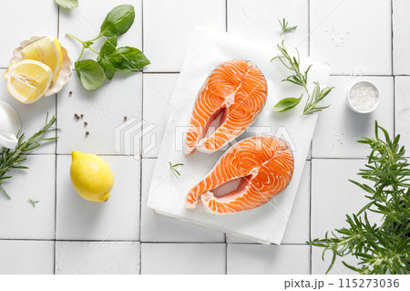 Fresh salmon steaks with herbs and ingredients for cooking, top view 115273036