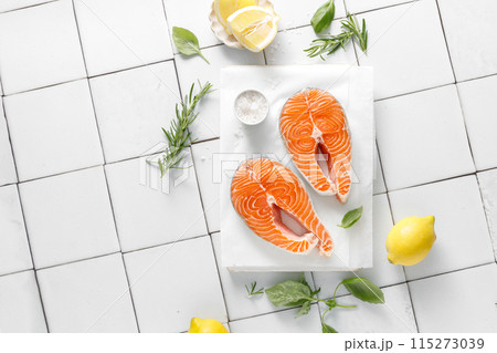 Fresh salmon steaks with herbs and ingredients for cooking, top view 115273039