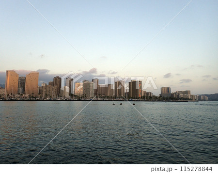Skyline of Waikiki at sunset or dusk with yachts and boats in Ala Moana harbor Skyline of Waikiki at sunset or dusk with yachts and boats in Ala Moana harbor 115278844