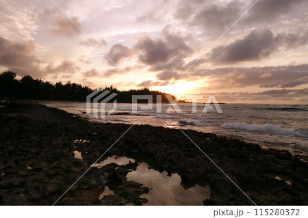 Sunset through the clouds and reflecting 115280372