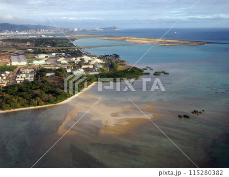 Honolulu International Airport and Coral reef Runway seen from the air with surrounding water and Honolulu city in the distance Honolulu International Airport and Coral reef Runway seen from the air with surrounding water and Honolulu city in the distance 115280382