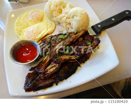 Kalbi steak ribs with two eggs over easy, two scoops of rice and cup of ketchup 115280420