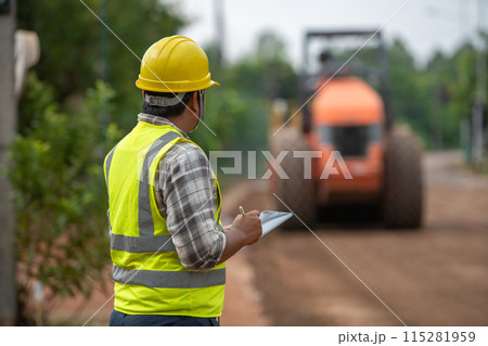 Civil engineer inspects road roller to build asphalt road Civil engineer inspects road roller to build asphalt road 115281959