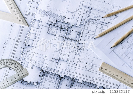 Architectural engineering design plan drawing on the table. Architect's work on table in studio. Construction design and plan Architectural engineering design plan drawing on the table. Architect's work on table in studio. Construction design and plan 115285137