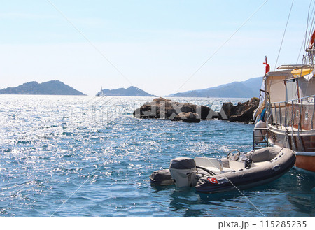 Motor boat is moored to yacht at sea at anchor. Holidays, travel, luxury 115285235