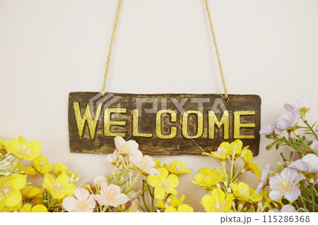 Welcome Sign with flowers frame decorate on pink background 115286368