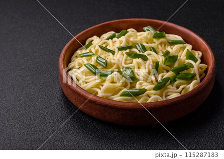 Delicious Asian cuisine dish with rice noodles, peppers, mushrooms and spices Delicious Asian cuisine dish with rice noodles, peppers, mushrooms and spices 115287183