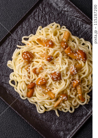 Delicious Asian cuisine dish with rice noodles, peppers, mushrooms and spices 115287200