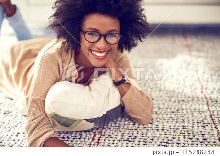 Portrait, black woman and relax on floor at home on carpet for break or peace with smile for weekend to chill on living room. Happy, African and female person with glasses for resting at apartment Portrait, black woman and relax on floor at home on carpet for break or peace with smile for weekend to chill on living room. Happy, African and female person with glasses for resting at apartment 115288238