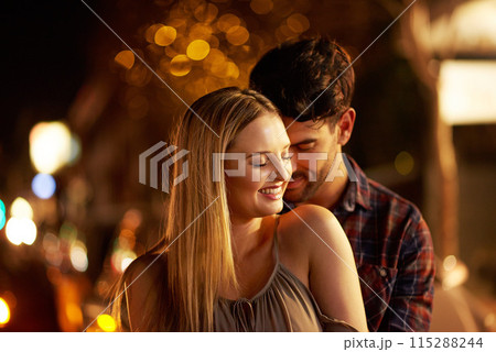 Couple, people and affection with smile in outdoor, together and support at night in London. Relationship, date and bonding for romance with sunset for care, relax and happiness as soulmate for love 115288244
