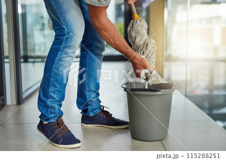 Janitor, mop or cleaning floor in office for housekeeping, building maintenance and hygiene services. Bucket, hospitality professional or caretaker in workplace for health, maintenance or bacteria 115288251