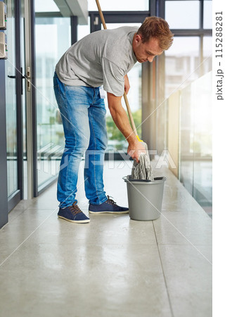 Janitor, mop or cleaning floor in office for housekeeping, building maintenance and hygiene services. Bucket, hospitality professional or caretaker in workplace for health, maintenance or bacteria Janitor, mop or cleaning floor in office for housekeeping, building maintenance and hygiene services. Bucket, hospitality professional or caretaker in workplace for health, maintenance or bacteria 115288281