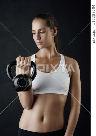 Woman, fitness and sport with kettle bell for weight lifting, strength training and exercise isolated in studio. Female person or bodybuilder and equipment for endurance workout, health and wellness Woman, fitness and sport with kettle bell for weight lifting, strength training and exercise isolated in studio. Female person or bodybuilder and equipment for endurance workout, health and wellness 115288304
