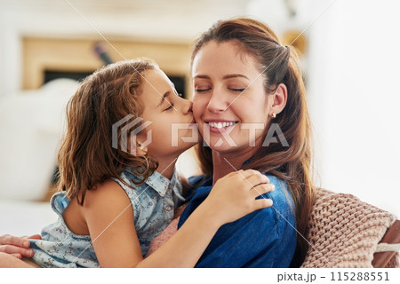 Kiss, mother and girl in home for love with connection, affection and comfort with safety or security on mothers day. Mom, daughter and bonding together on sofa for support, moments and care. Kiss, mother and girl in home for love with connection, affection and comfort with safety or security on mothers day. Mom, daughter and bonding together on sofa for support, moments and care. 115288551