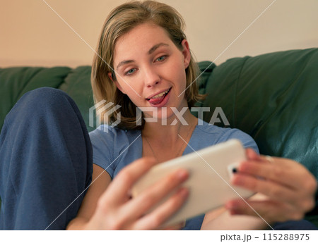Funny face, woman and selfie on sofa in home for social media, goofy memory and post online. Photography, picture and girl with tongue out for comic, comedy emoji or crazy influencer in living room Funny face, woman and selfie on sofa in home for social media, goofy memory and post online. Photography, picture and girl with tongue out for comic, comedy emoji or crazy influencer in living room 115288975