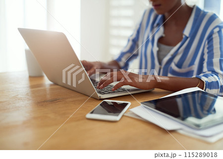 Laptop, woman and hands typing at desk for blog, social media and email in apartment. African female journalist, technology and work from home for research, newspaper article and online magazine 115289018