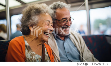 Cheerful mature couple travelling by train, responsible travel concept 115289105
