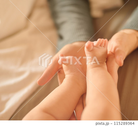 Hands, baby feet and home in bedroom, newborn and family for love, care and nurture. Bonding, support and childhood in person, infant and parent with tiny, toddler and connection, skin and develop 115289364