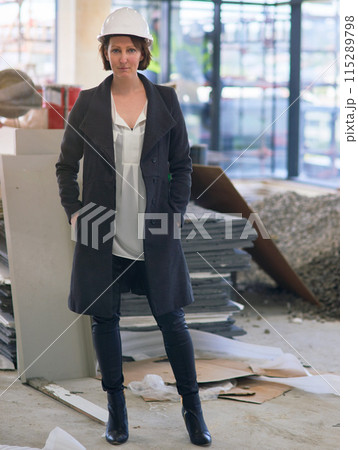 Portrait, helmet and woman in site for construction, affirmative action and inspector visit in building. Contractor, female employee and inspection of property, development and report for company 115289798