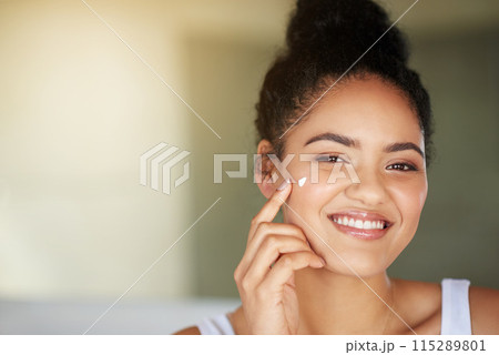 Happy woman, portrait and skincare with cream for moisturizing or facial treatment at home. Face of young female person or model with smile, lotion or creme for anti aging skin or cosmetics at house 115289801