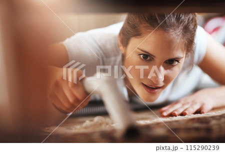 Woman, vacuum and cleaning floor in home for hygiene, housework or housekeeping service for safety. Chores, maid and electrical appliance to suck dirt, dust and bacteria on carpet with face closeup Woman, vacuum and cleaning floor in home for hygiene, housework or housekeeping service for safety. Chores, maid and electrical appliance to suck dirt, dust and bacteria on carpet with face closeup 115290239