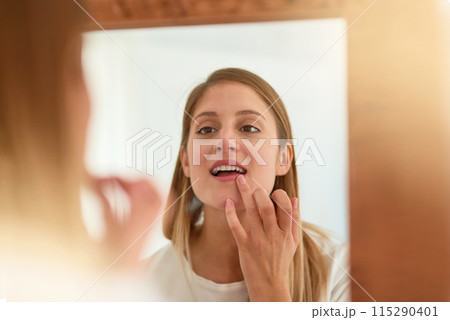 Woman, home and mirror with applying lipgloss for beauty, reflection and confident with results. Female person, face and lipstick for aesthetics, cosmetics and transformation for self care and love Woman, home and mirror with applying lipgloss for beauty, reflection and confident with results. Female person, face and lipstick for aesthetics, cosmetics and transformation for self care and love 115290401