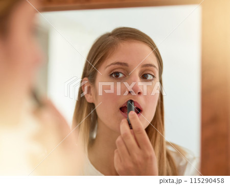 Woman, home and mirror with lipstick for beauty, reflection and confident with results. Female person, face and lips for appearance, aesthetics and cosmetics for transformation with self care 115290458