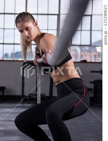 Fitness, woman and pull rope in gym for power workout, grip strength or intense cardio exercise. Sports, athlete and female person with tug of war for performance, muscle endurance or arm training Fitness, woman and pull rope in gym for power workout, grip strength or intense cardio exercise. Sports, athlete and female person with tug of war for performance, muscle endurance or arm training 115290621