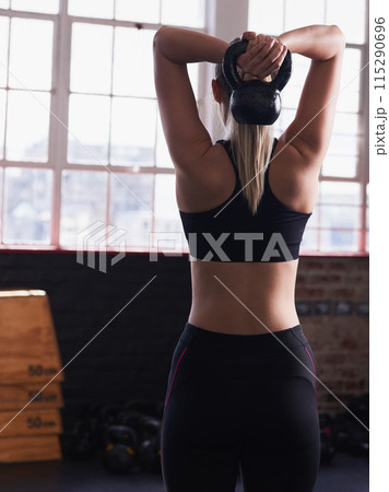 Woman, back and gym and lifting kettlebell, strength and health goals for wellness or exercise training with athlete. Body builder, workout club and sports target, goal for muscle development Woman, back and gym and lifting kettlebell, strength and health goals for wellness or exercise training with athlete. Body builder, workout club and sports target, goal for muscle development 115290696