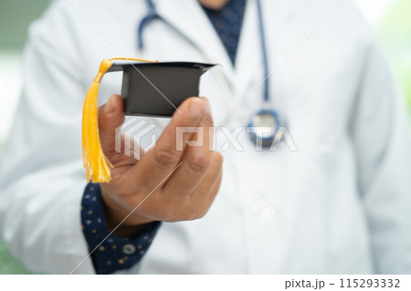 Asian doctor study learn with graduation gap hat in hospital ward, clever bright genius education medicine concept. Asian doctor study learn with graduation gap hat in hospital ward, clever bright genius education medicine concept. 115293332