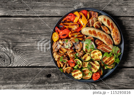 grilled white sausages with veggies and mushrooms 115293816
