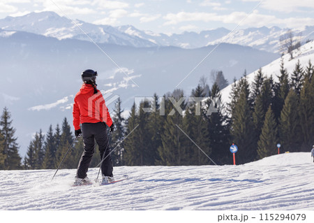 man and woman skiing and snowboarding in the mountains 115294079