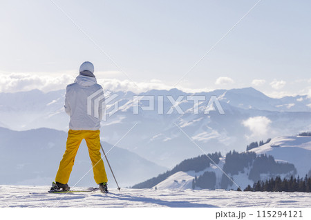 man and woman skiing and snowboarding in the mountains 115294121