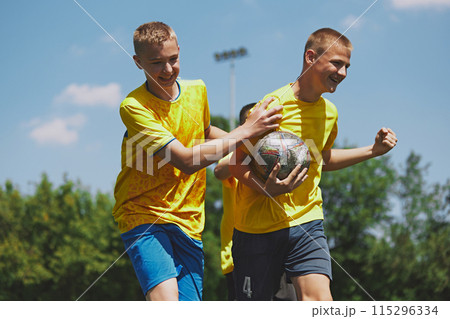 Team Spirit and Fun. Young soccer players express happiness and team spirit during playful moment after winning outdoor game session. Team Spirit and Fun. Young soccer players express happiness and team spirit during playful moment after winning outdoor game session. 115296334