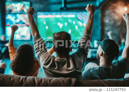 Friends sitting on couch and watching soccer on TV 115297793