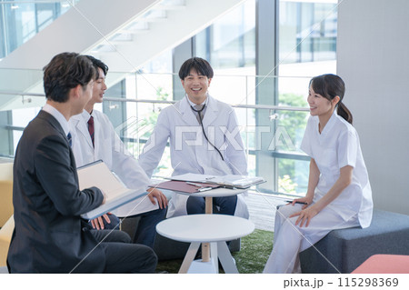 病院でミーティングする医師と看護師とビジネスマン 病院でミーティングする医師と看護師とビジネスマン 115298369