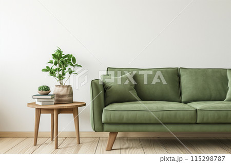 Minimalist living room with a clean and cozy aesthetic, featuring a green fabric sofa 115298787